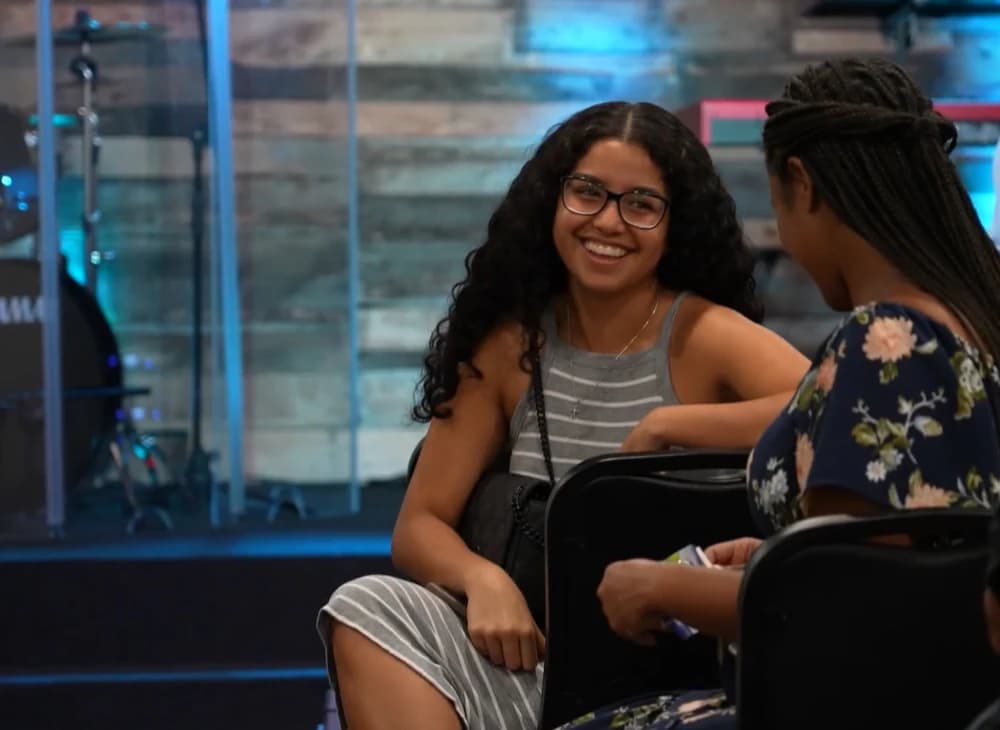 Two women sharing a conversation at Living Message Church.