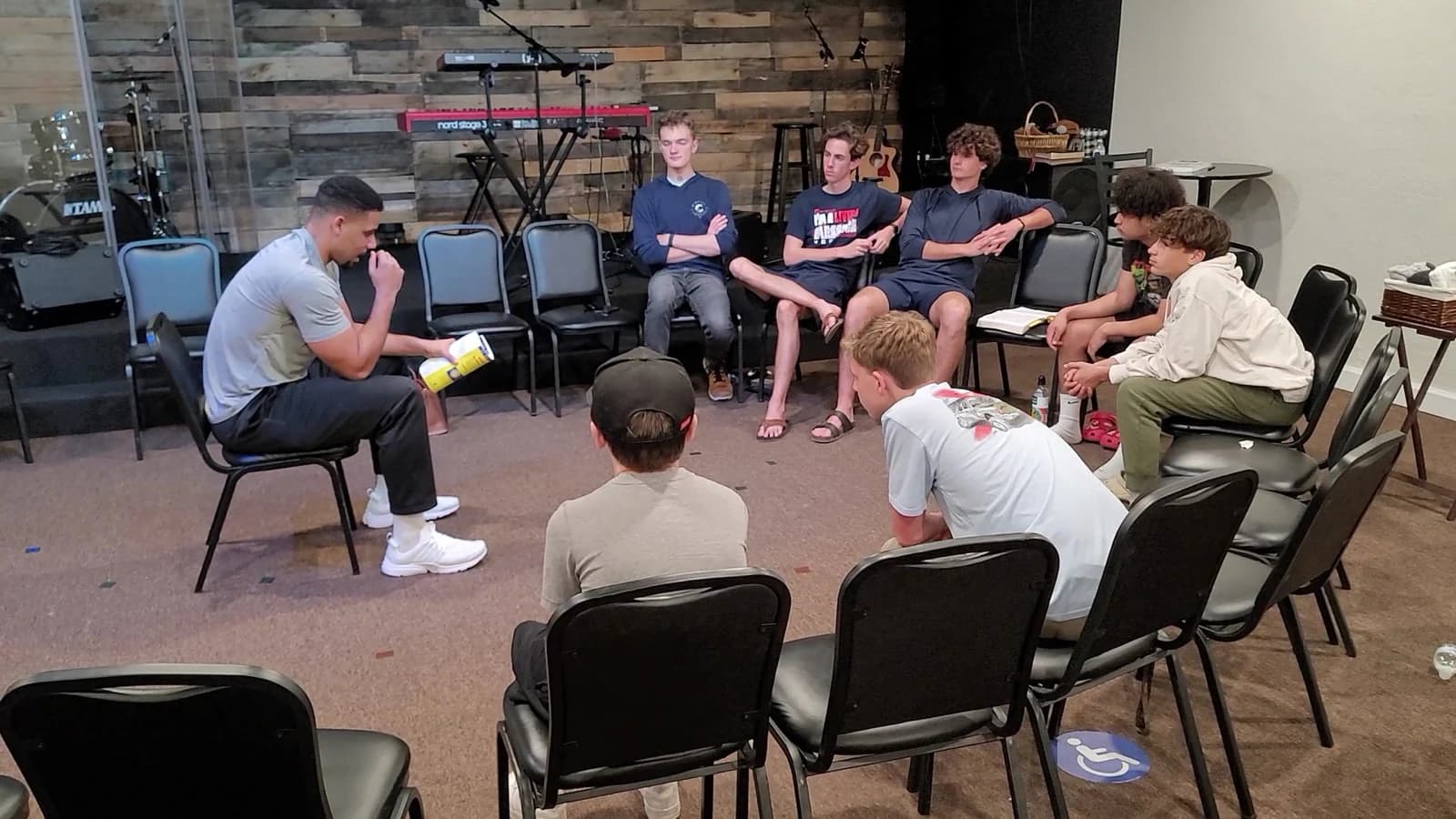 A small group gathered in a circle at Living Message Church.