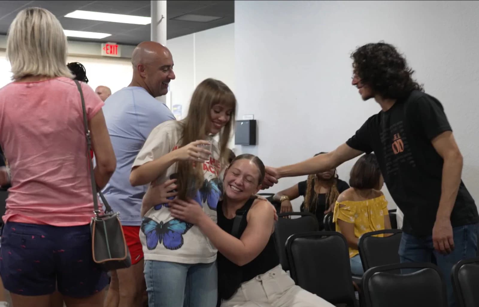 People welcoming one another at a Living Message Church gathering.