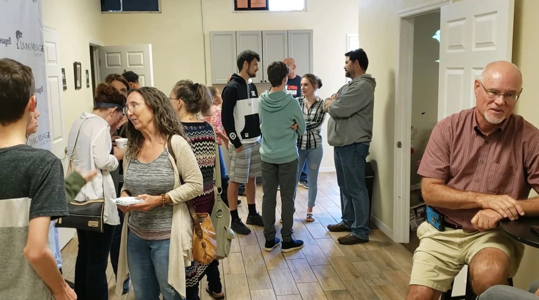 People connecting in the lobby at Living Message Church.