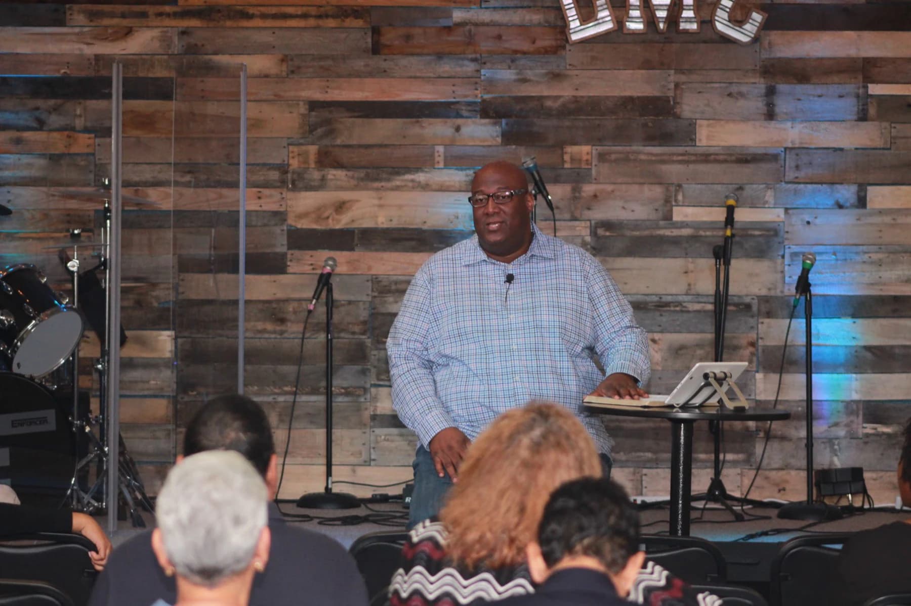 Pastor Brian Broadway teaching from the Living Message Church stage.